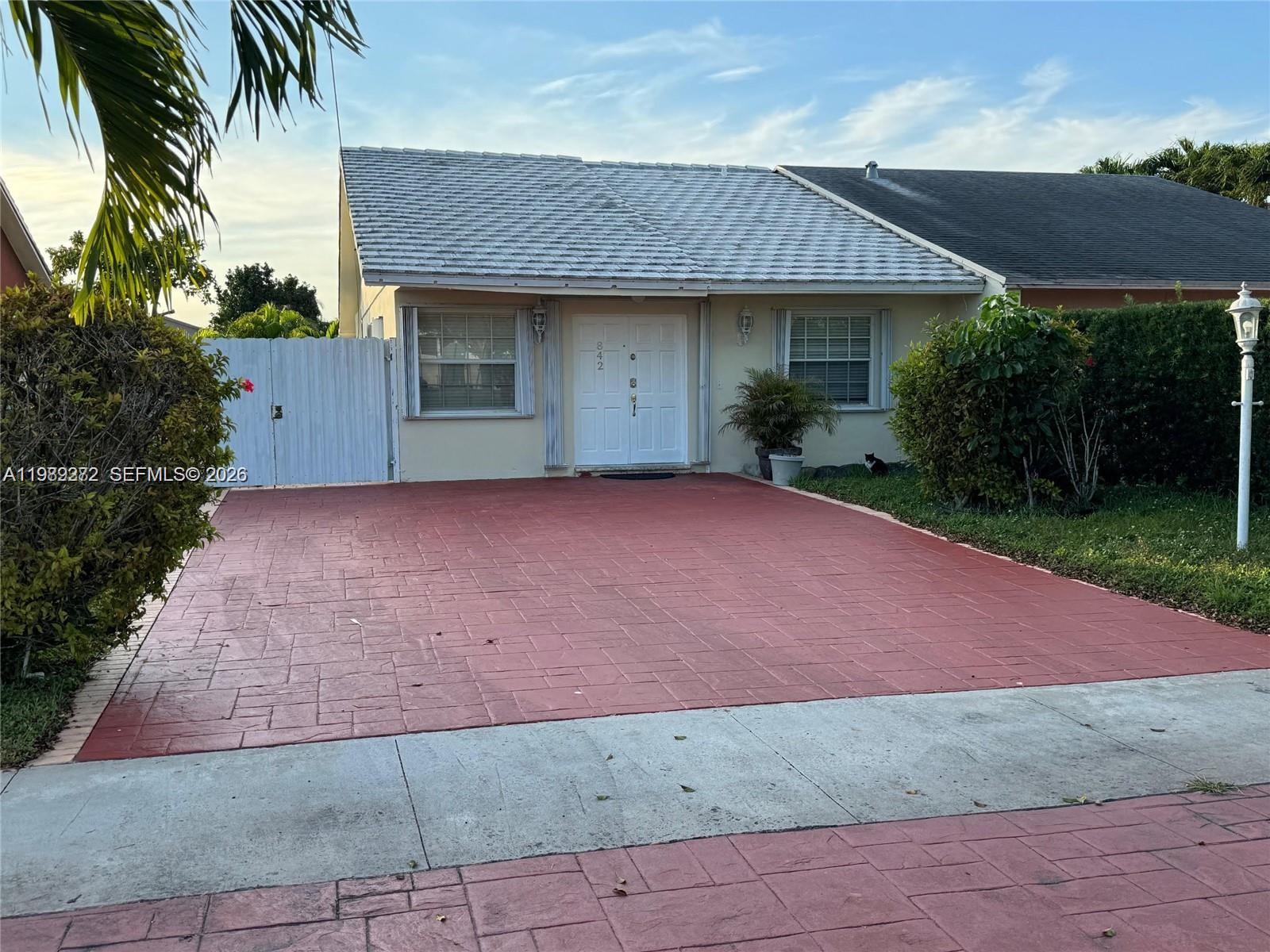 842 Southwest 89th Avenue, Unit B Miami, FL 33174 - Photo 1 of 7 a front view of a house with a garden