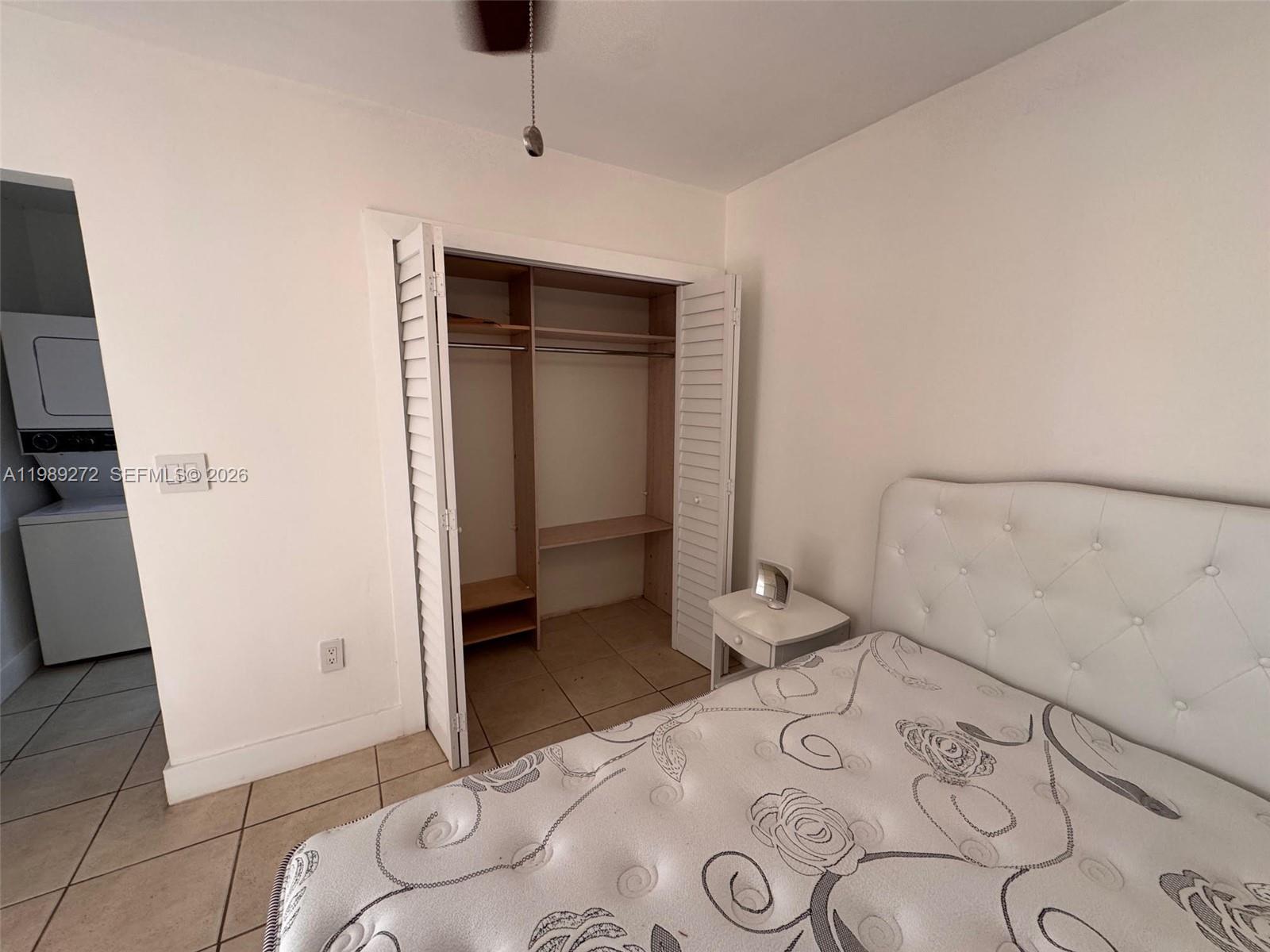 842 Southwest 89th Avenue, Unit B Miami, FL 33174 - Photo 5 of 7 a bedroom with a bed and a dresser