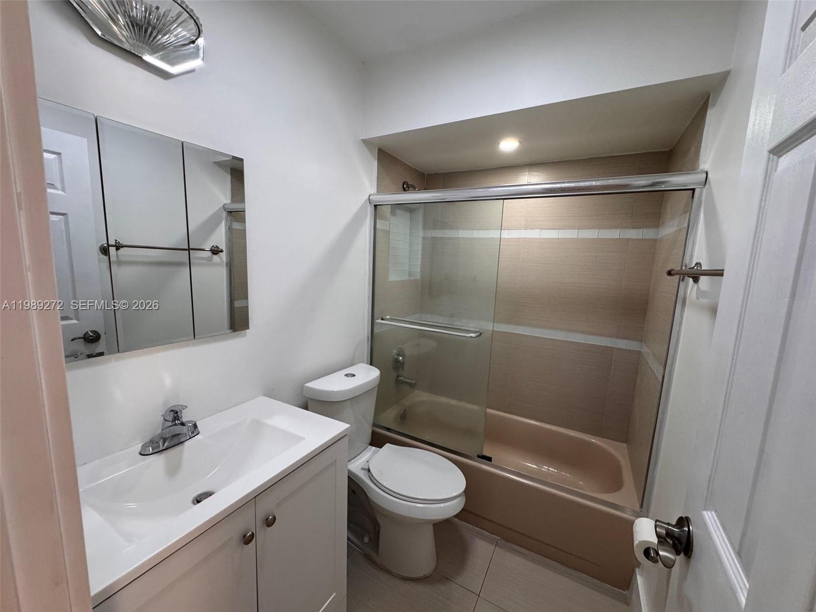 842 Southwest 89th Avenue, Unit B Miami, FL 33174 - Photo 7 of 7 a bathroom with a granite countertop sink toilet and shower