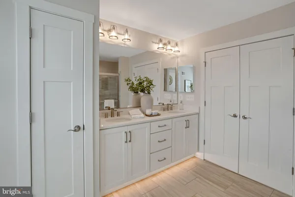 a bathroom with a double vanity sink and a mirror