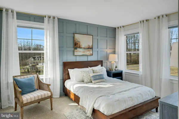 a bedroom with a large bed and a window