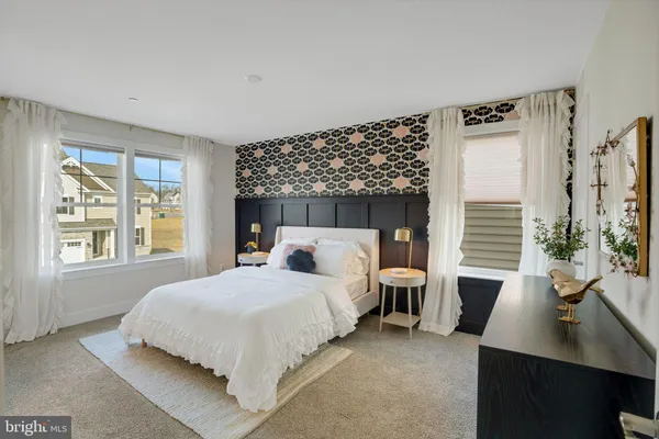 a bedroom with a large bed and a window