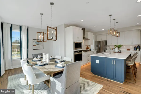 a kitchen with stainless steel appliances kitchen island granite countertop a sink and cabinets