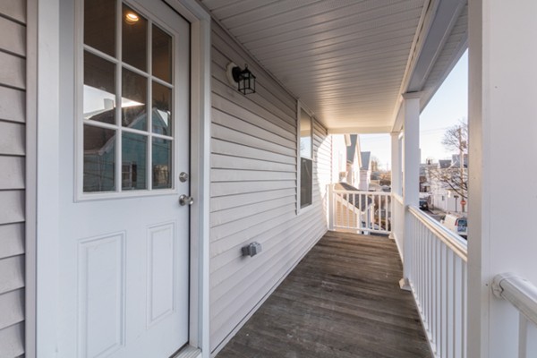 39 Montrose Street, Unit 2 Everett, MA 02149 - Photo 12 of 12 a view of a balcony with wooden floor and fence