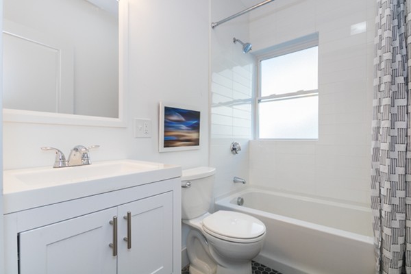 39 Montrose Street, Unit 2 Everett, MA 02149 - Photo 6 of 12 a bathroom with a sink toilet a mirror and shower