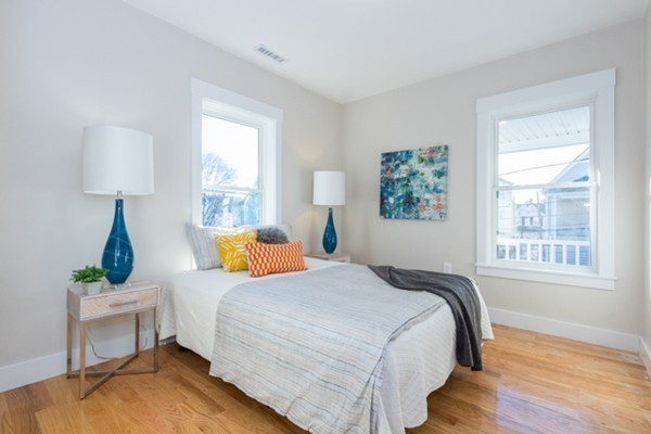 39 Montrose Street, Unit 2 Everett, MA 02149 - Photo 9 of 12 a bed room with a bed and a lamp