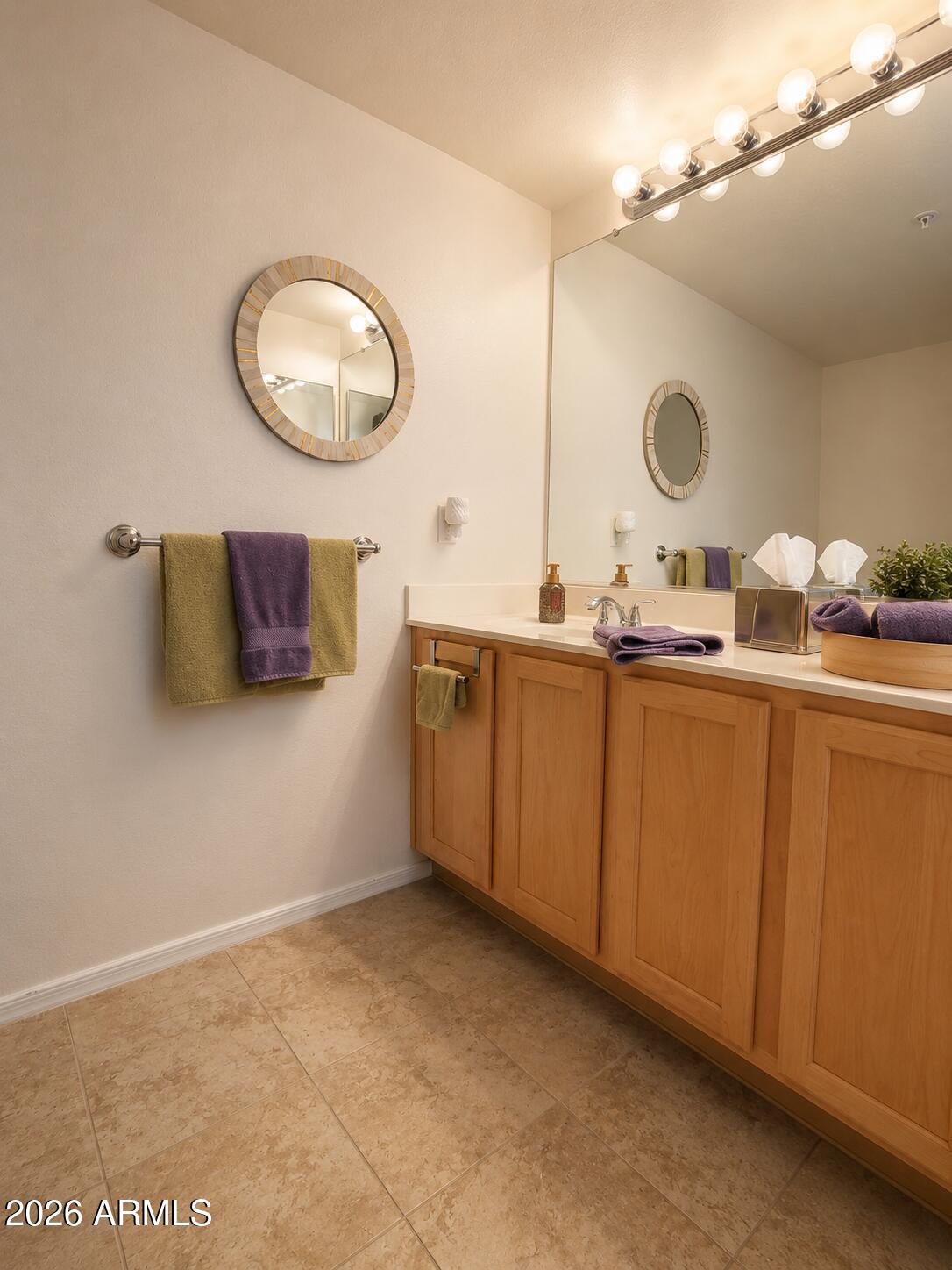 2150 West Alameda Road, Unit 1020 Phoenix, AZ 85085 - Photo 29 of 35 a bathroom with a sink vanity and a mirror