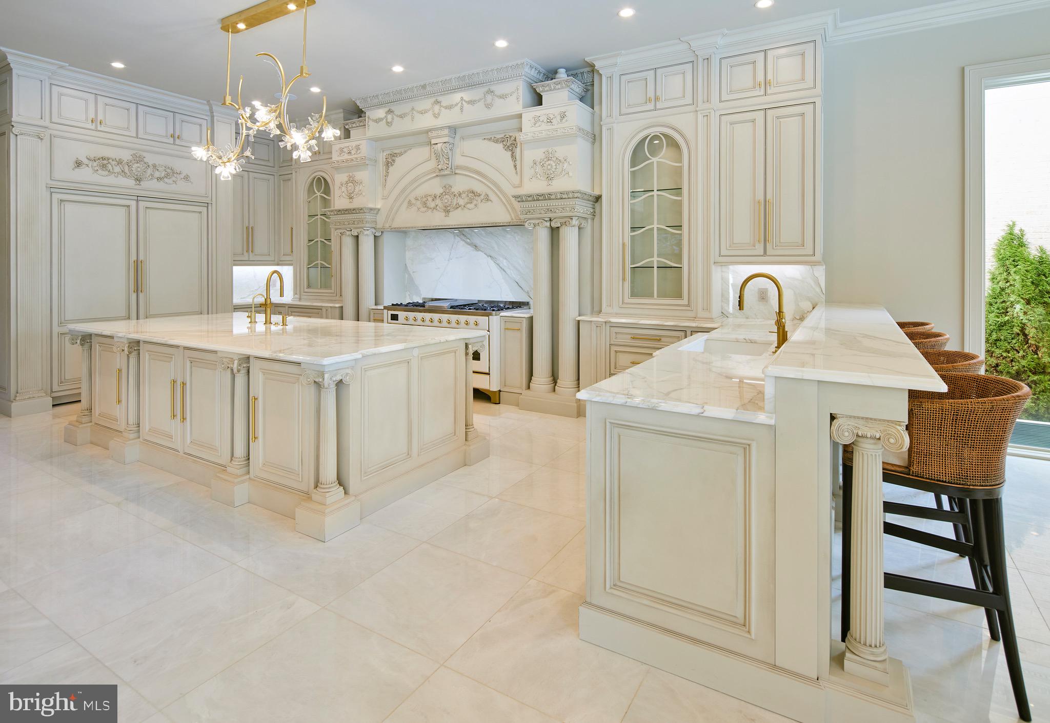6431 Georgetown Pike McLean, VA 22101 - Photo 17 of 57 a large white kitchen with a sink a stove a dining table and chairs