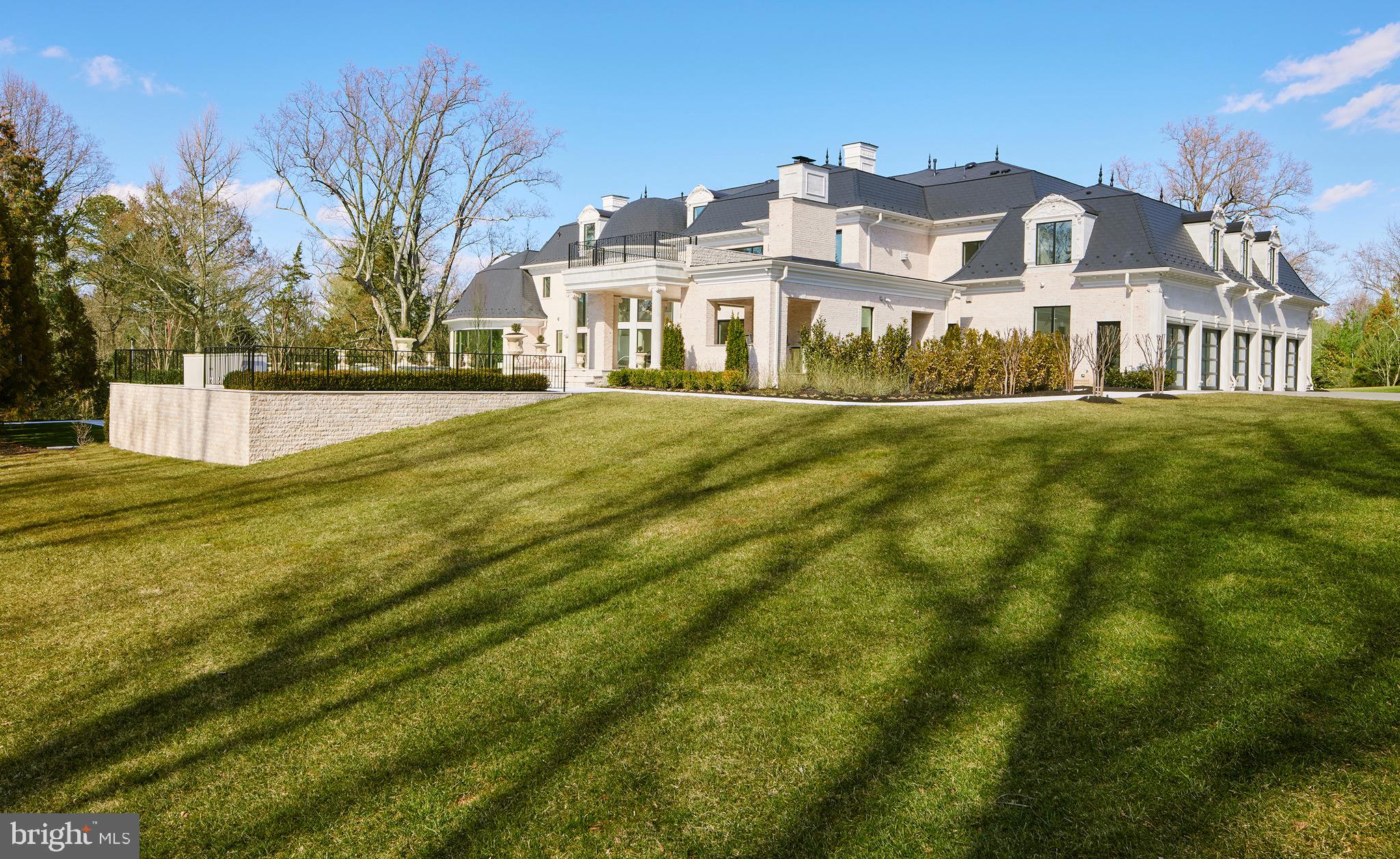 6431 Georgetown Pike McLean, VA 22101 - Photo 54 of 57 a front view of residential houses with yard and trees in the background