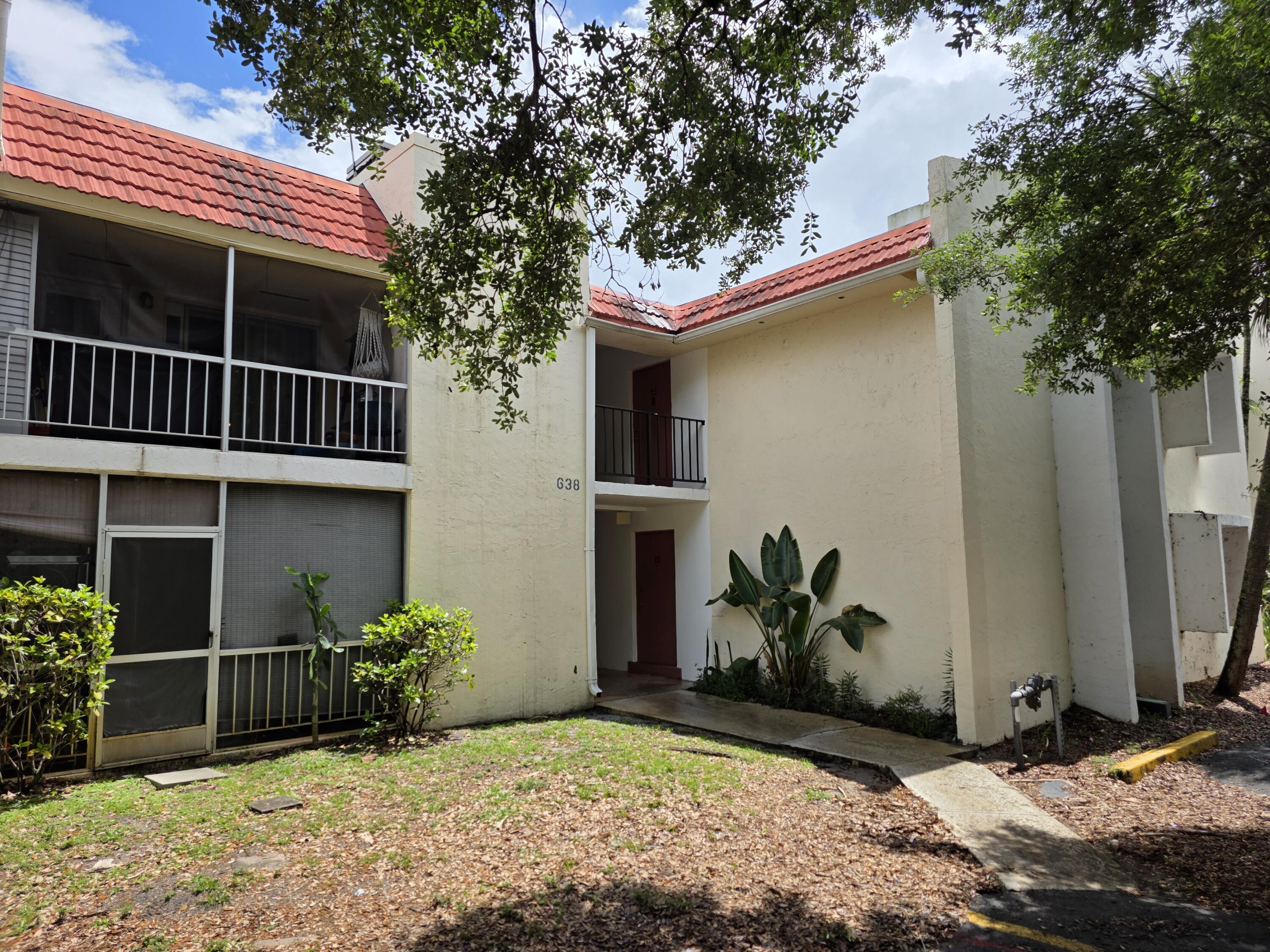 683 Northwest 13th Street, Unit 27 Boca Raton, FL 33486 - Photo 15 of 16 a view of a house with a yard