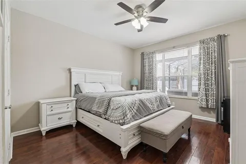 a bedroom with a large bed and a chandelier