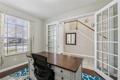 a view of a workspace with furniture and a window