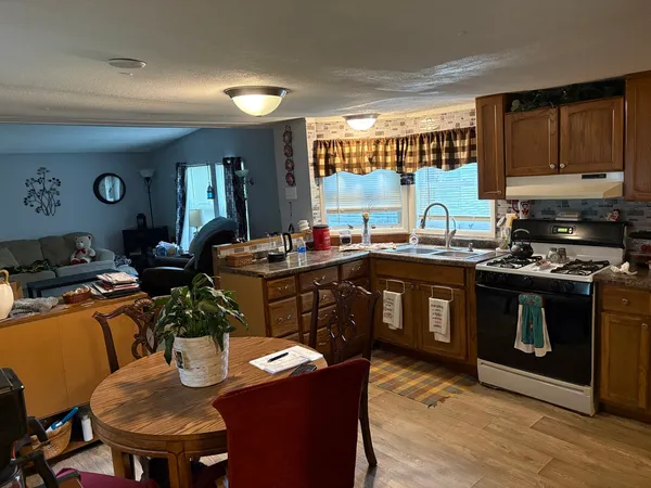 a kitchen with a stove a sink and a refrigerator