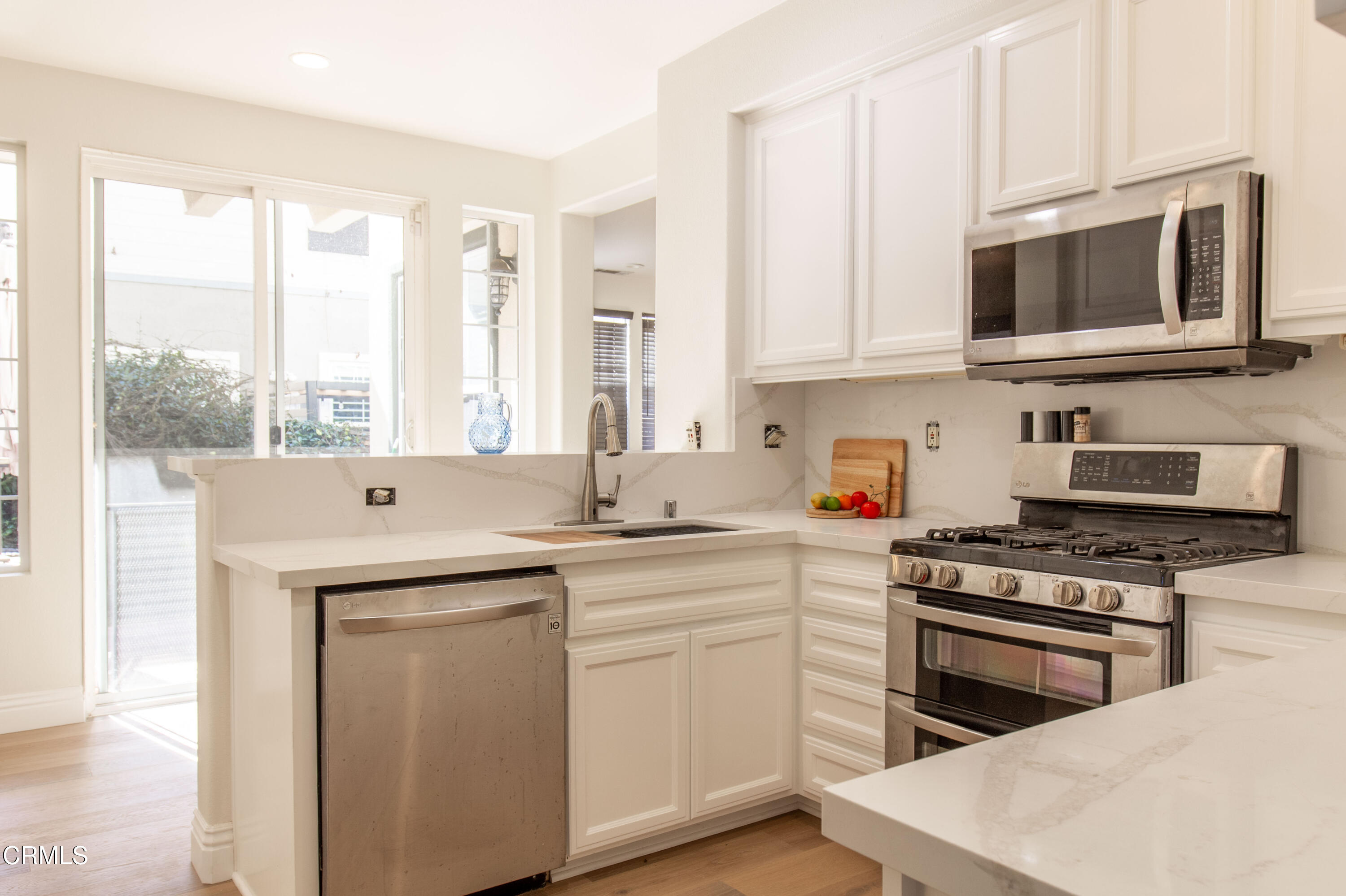 37 St Mays Road Ladera Ranch, CA 92694 - Photo 8 of 27 a kitchen with a stove a sink and a microwave