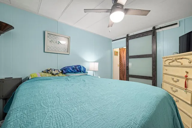 a bed room with a bed and a chair