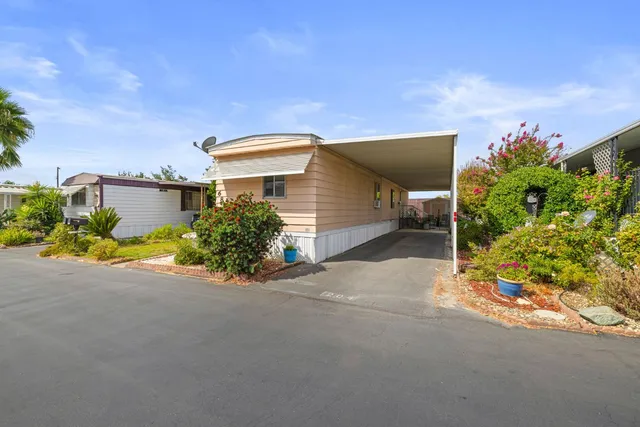 a view of a house with a garage and a yard