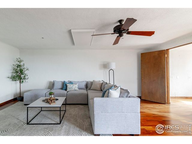 a living room with furniture a rug and a painting on the wall