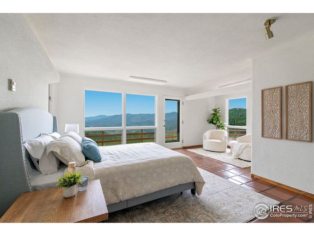 a bedroom with a large bed and a view of living room