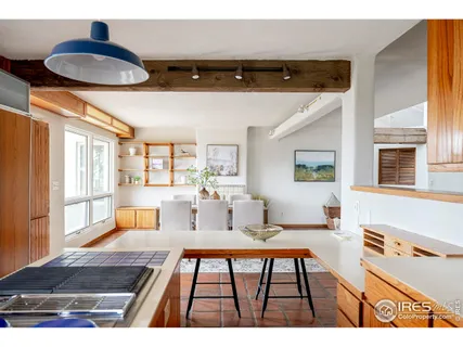 a kitchen with stainless steel appliances a sink stove and table
