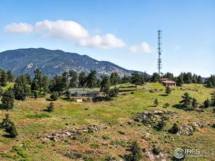 a view of a house with a mountain in the background