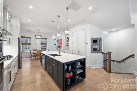 a kitchen with kitchen island a stove a sink and a refrigerator