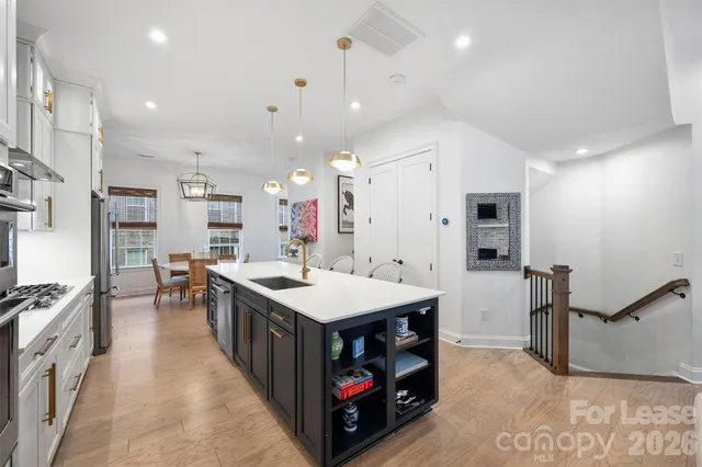 a kitchen with kitchen island a stove a sink and a refrigerator