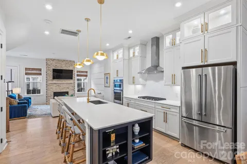 a kitchen with sink refrigerator and stove