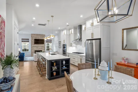 a living room with furniture a dining table and kitchen view