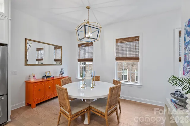 a dining room with furniture a rug and a chandelier