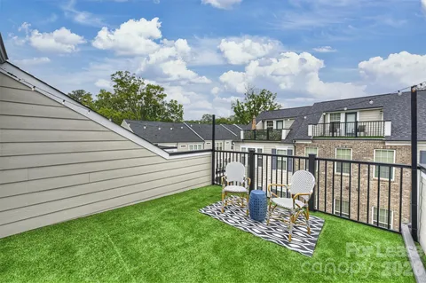 a view of a porch with furniture and a yard