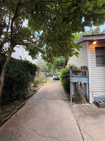 a view of a house with a tree and a yard