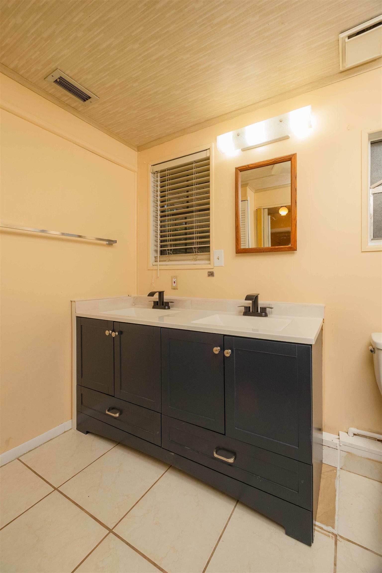 7557 Highway 1 St. Augustine, FL 32086 - Photo 22 of 60 a bathroom with a sink vanity and mirror