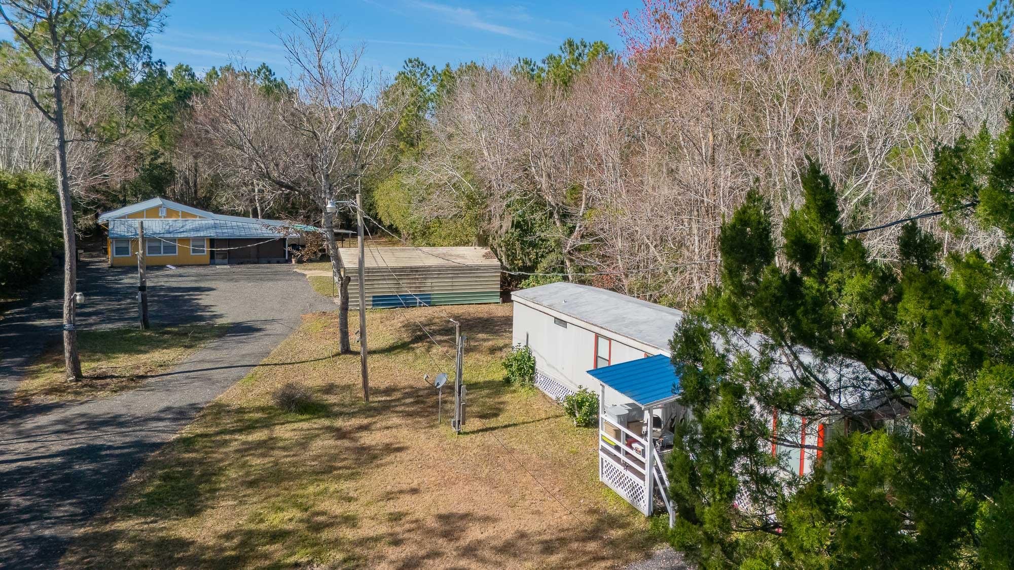 7557 Highway 1 St. Augustine, FL 32086 - Photo 32 of 60 a view of a chairs and table in the backyard
