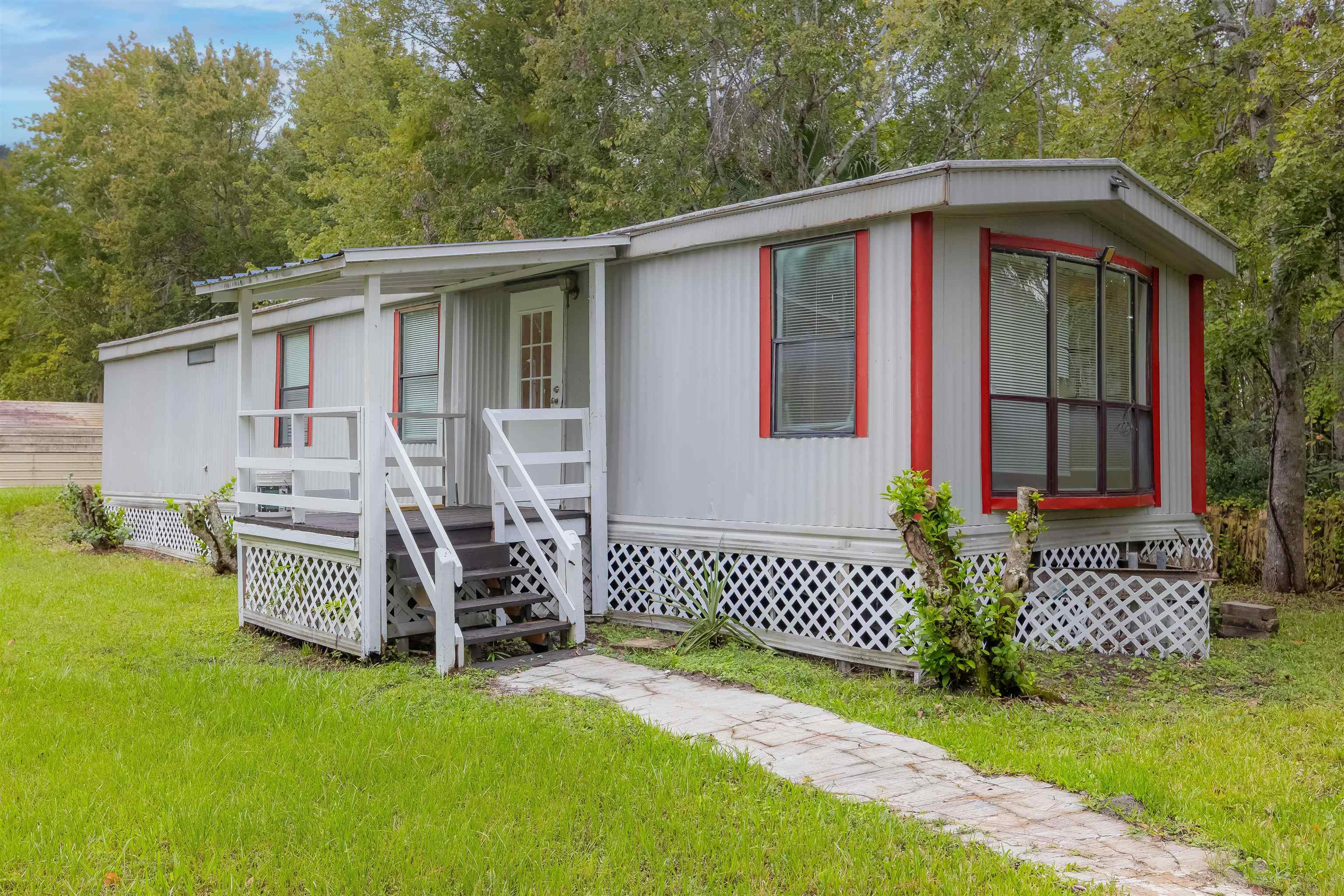 7557 Highway 1 St. Augustine, FL 32086 - Photo 37 of 60 a front view of a house with garden