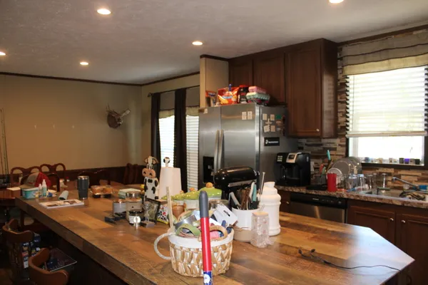 a kitchen with refrigerator and sink