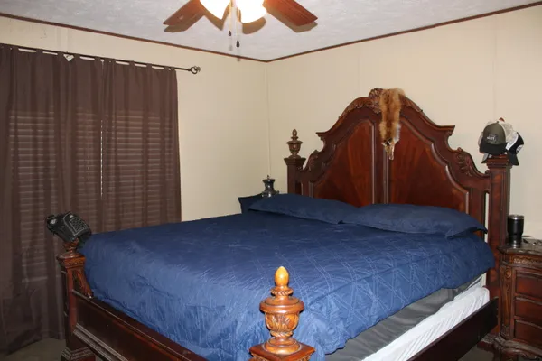 a bedroom with a bed and a chandelier