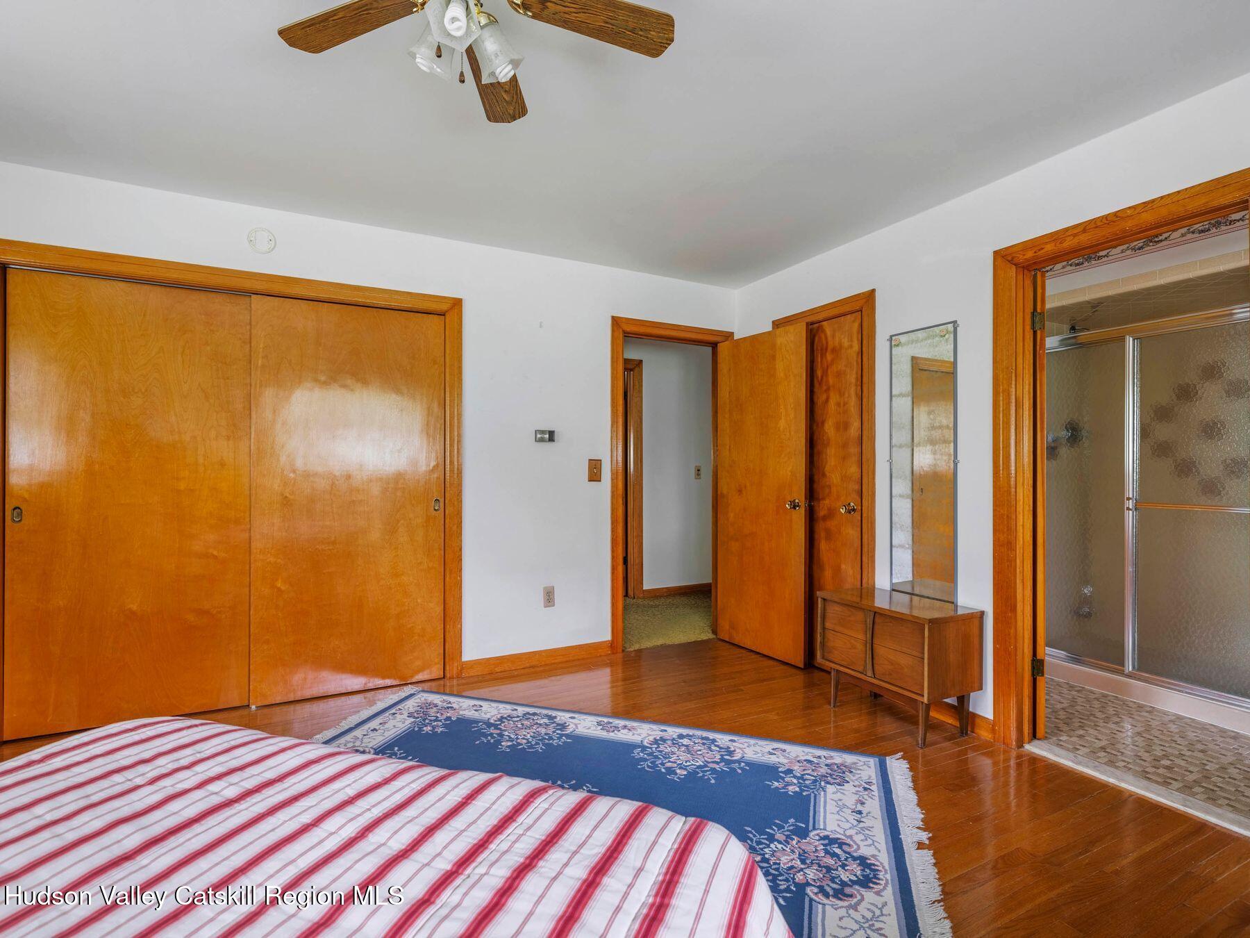 104 New Paltz Road Highland, NY 12528 - Photo 21 of 43 a bedroom with a bed and a chandelier