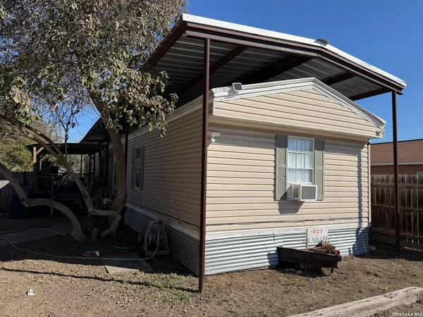 a view of a house with a door and wooden roof