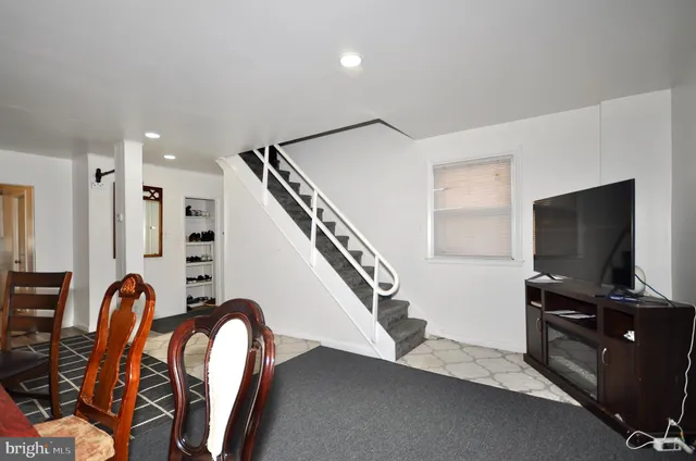 a view of a livingroom with furniture and staircase