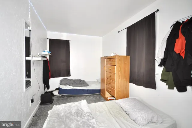 a bedroom with a bed and flat screen tv