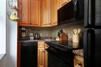 a kitchen with stainless steel appliances granite countertop a stove and a microwave