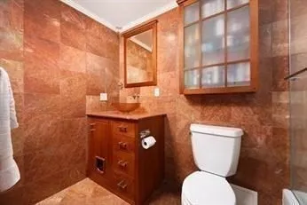 a bathroom with a toilet a sink and a shower curtain
