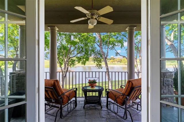 a view of a patio with a table chairs and a small yard