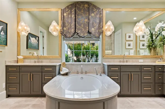 a bathroom with a sink a large mirror and a window