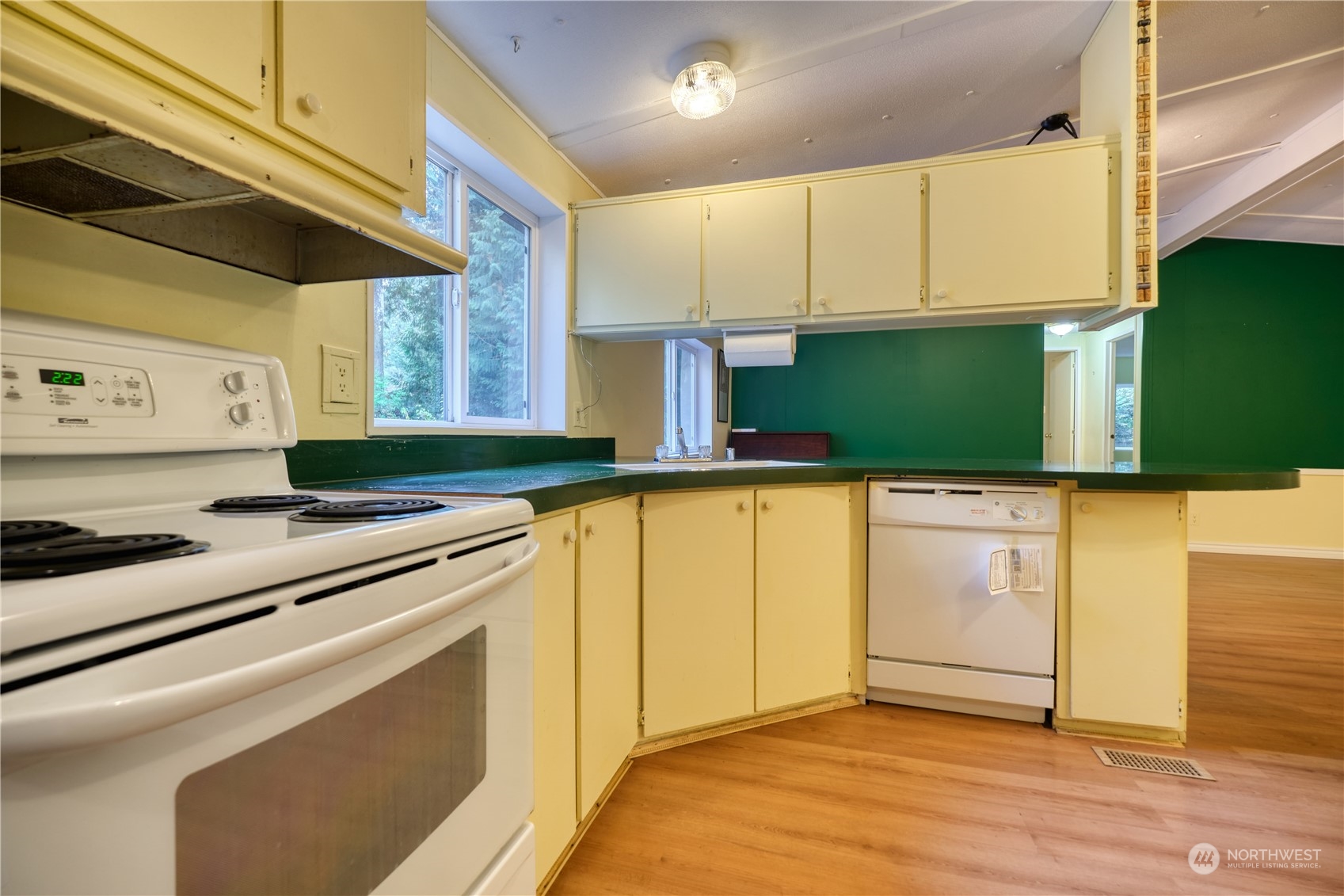 156 Mill Road Point Roberts, WA 98281 - Photo 11 of 27 a kitchen with granite countertop a stove a sink and a microwave