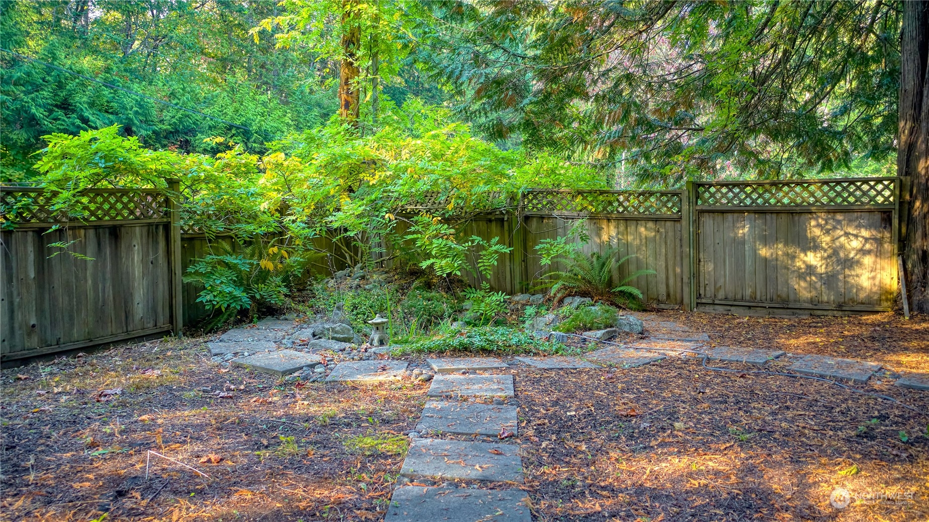 156 Mill Road Point Roberts, WA 98281 - Photo 3 of 27 a backyard of a house with lots of green space and lake view