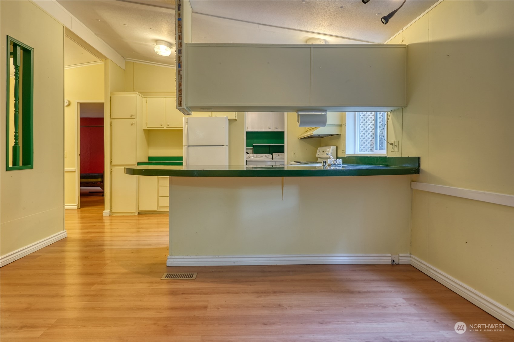 156 Mill Road Point Roberts, WA 98281 - Photo 8 of 27 a view of a kitchen with kitchen island stainless steel appliances a sink and wooden floor