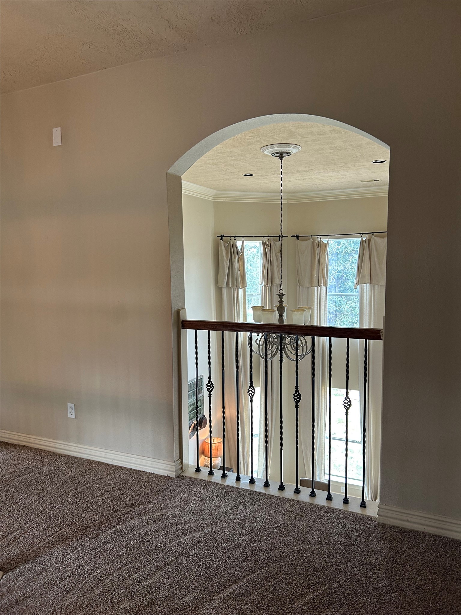 329 Flash Circle Luling, TX 78648 - Photo 23 of 32 An elegant arched opening overlooks the light-filled lower level from this carpeted upper landing.