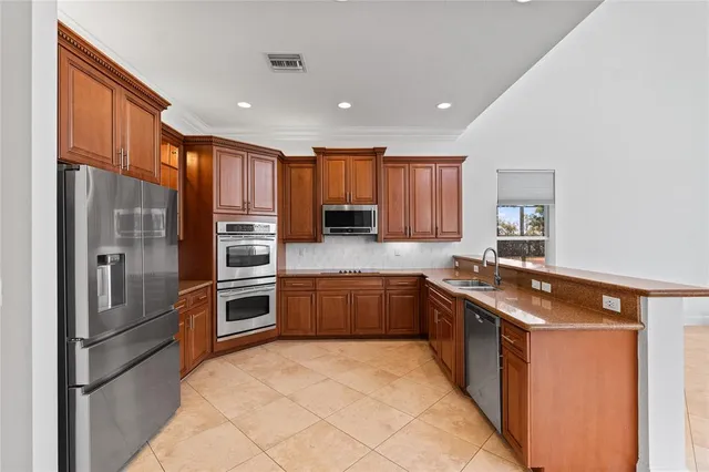 a view of kitchen with stainless steel appliances refrigerator and microwave