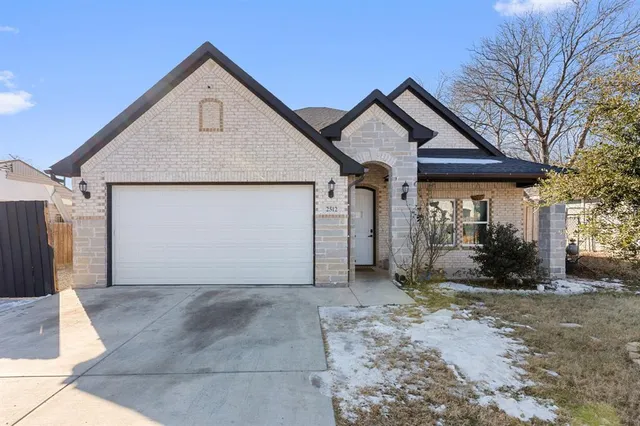 a view of a house with a yard and garage